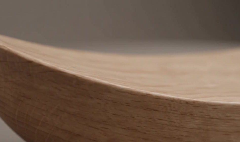 Close detail of the wooden cradle's curved edge